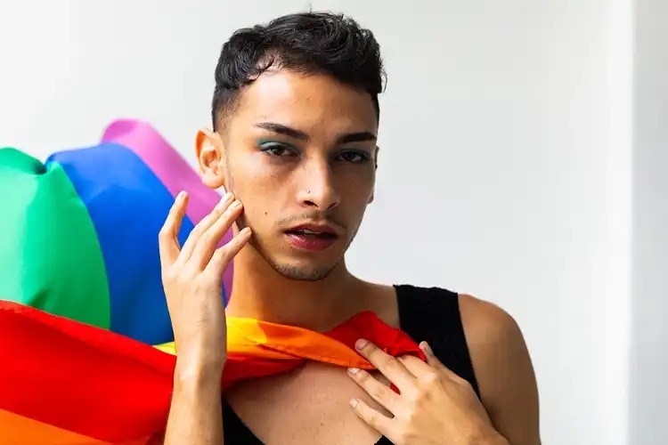 Portrait with a rainbow flag in the background