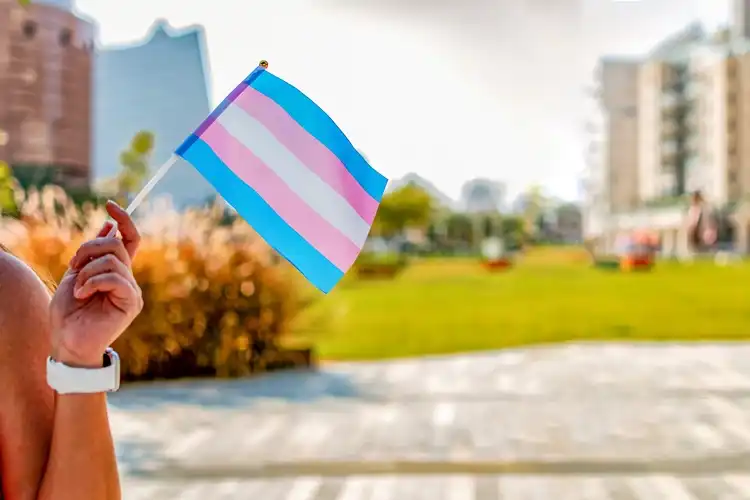 Hands holding a transgender flag as a symbol of community support
