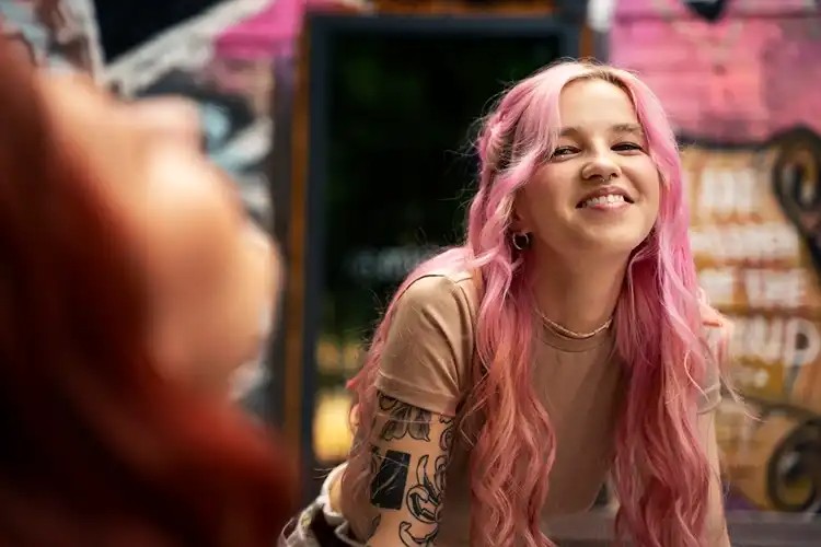 Friends laughing outdoors in summer